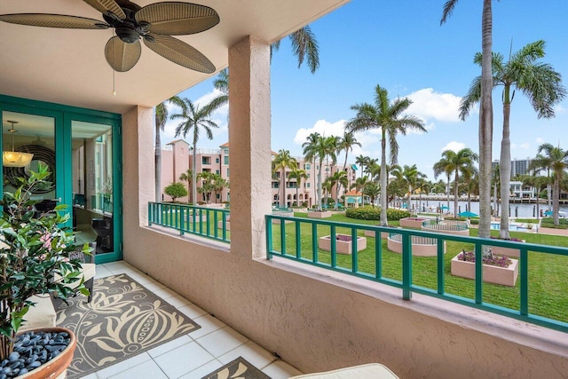 balcony with a water view and ceiling fan