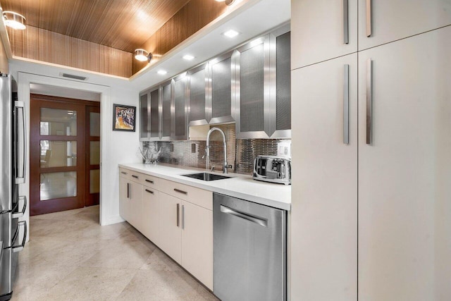 kitchen featuring stainless steel appliances, sink, and decorative backsplash