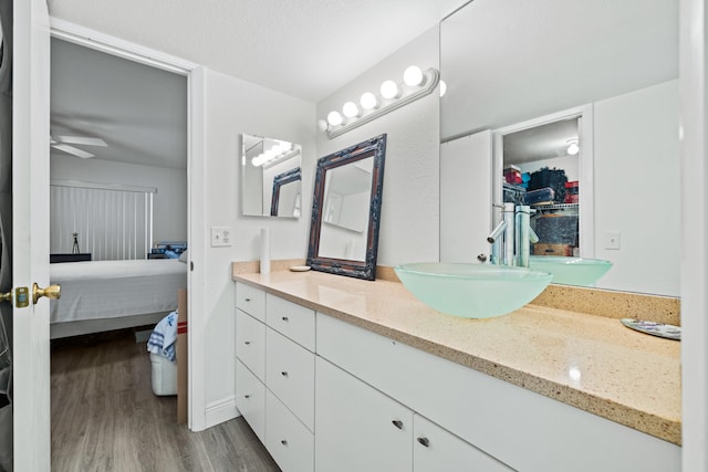 bathroom featuring ceiling fan, vanity, and hardwood / wood-style floors