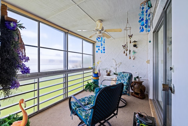 sunroom featuring ceiling fan