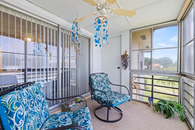 sunroom / solarium featuring ceiling fan