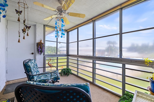 sunroom / solarium featuring ceiling fan