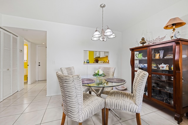 tiled dining room featuring an inviting chandelier