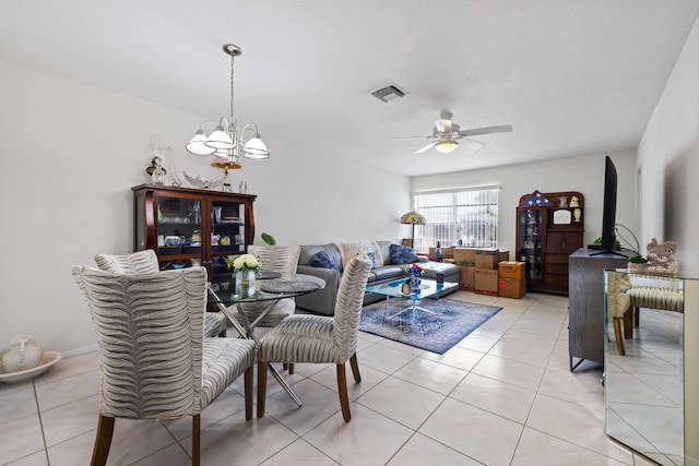 tiled living room featuring ceiling fan with notable chandelier