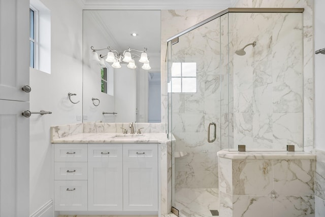 bathroom featuring ornamental molding, vanity, and a shower with shower door