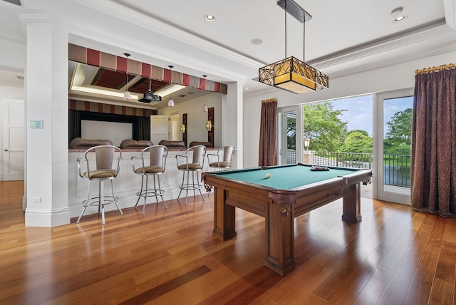 game room featuring crown molding, wood-type flooring, pool table, and bar