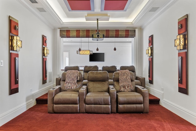 cinema room with carpet flooring, a tray ceiling, and ornamental molding