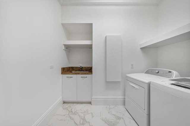 laundry area featuring ornamental molding, sink, and independent washer and dryer