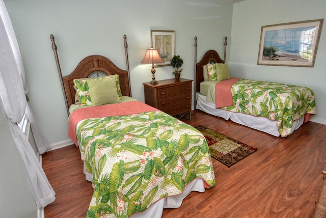 bedroom with dark wood-type flooring