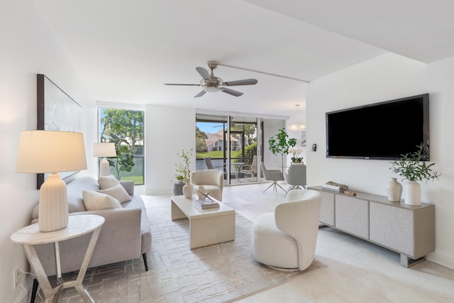 living room with a wall of windows and ceiling fan