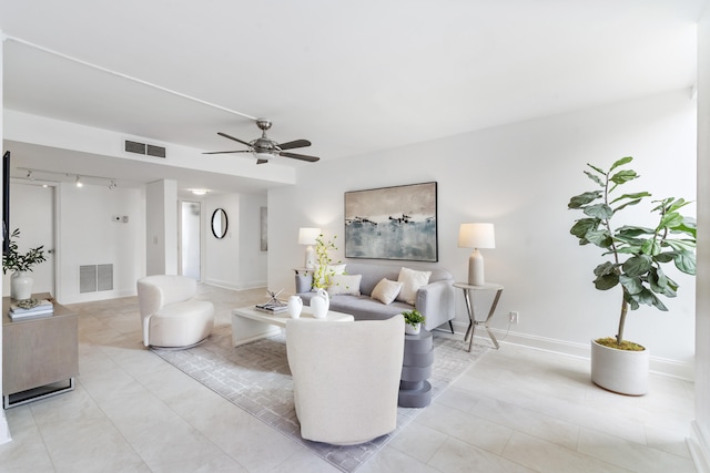 living room with ceiling fan and light tile patterned floors