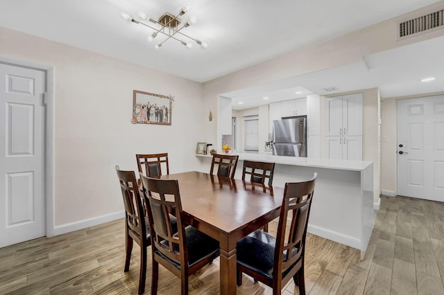 dining space featuring light wood-type flooring