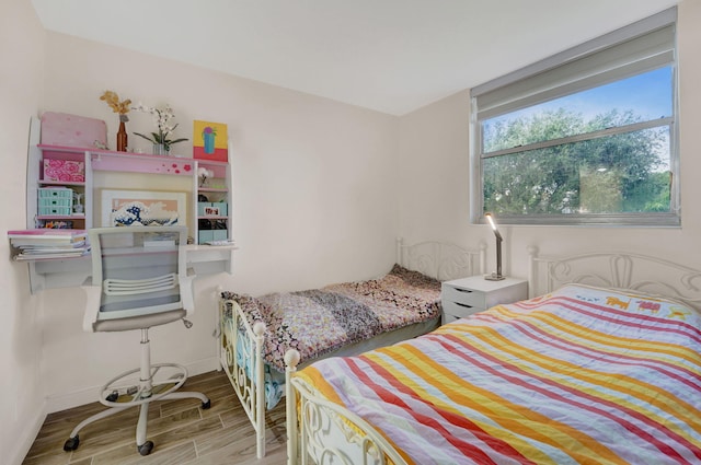 bedroom with hardwood / wood-style flooring