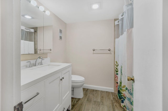 bathroom featuring vanity, toilet, and wood-type flooring