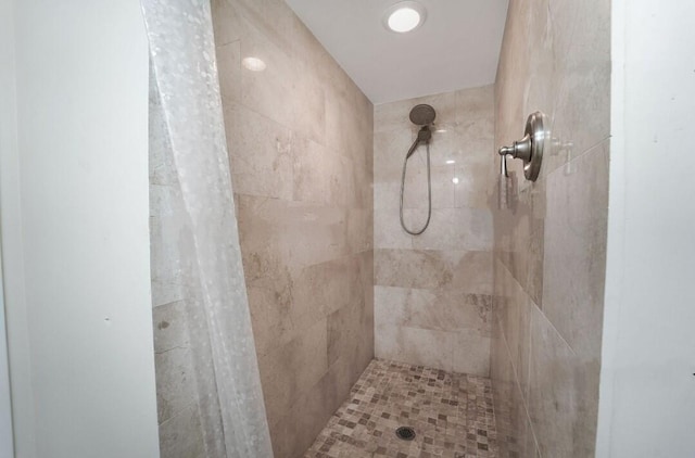 bathroom with a tile shower