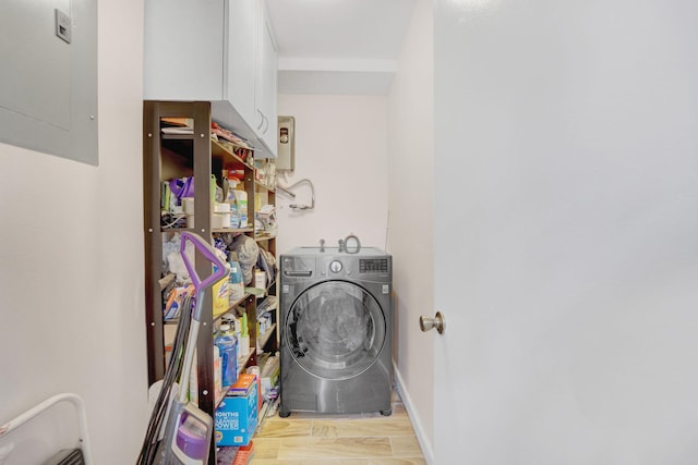 laundry area featuring light wood-type flooring, washer / dryer, and electric panel