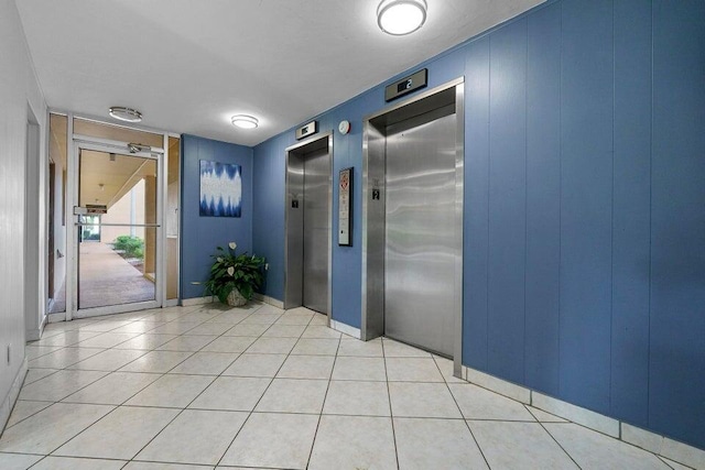 entryway featuring light tile patterned floors and elevator