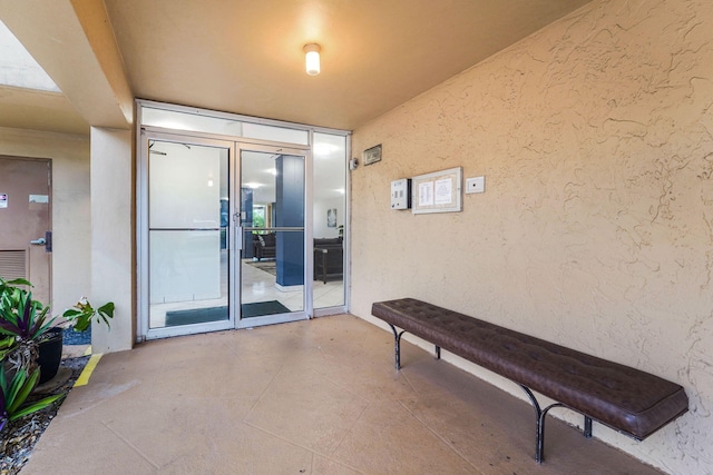 property entrance featuring a patio area and french doors