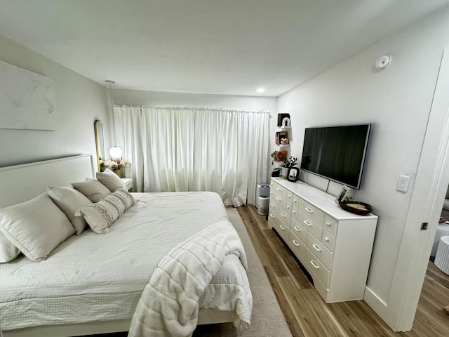 bedroom with hardwood / wood-style flooring