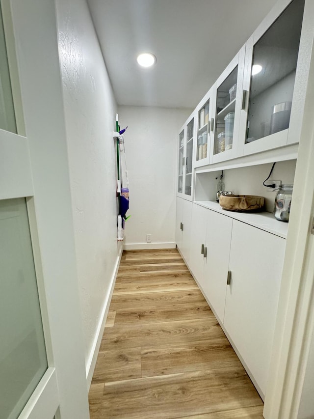 interior space featuring white cabinets and light hardwood / wood-style floors