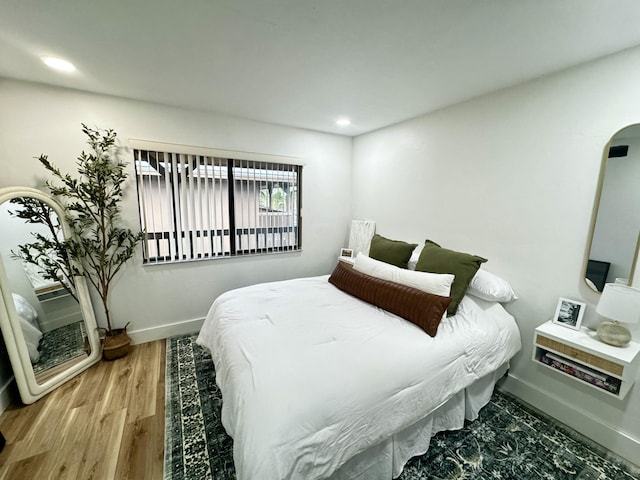 bedroom with wood-type flooring