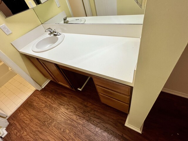 bathroom featuring hardwood / wood-style flooring and vanity