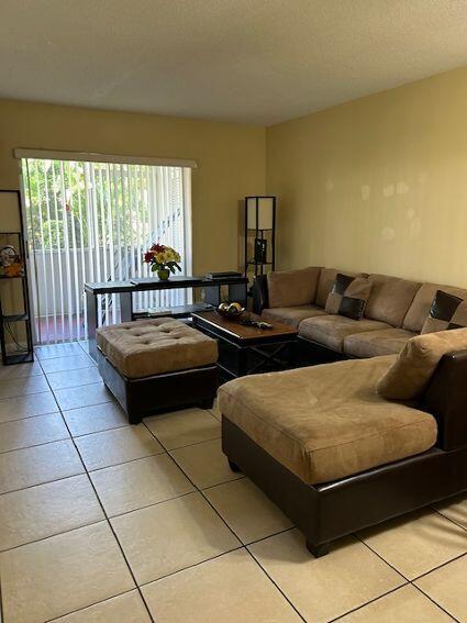 tiled living room with a textured ceiling