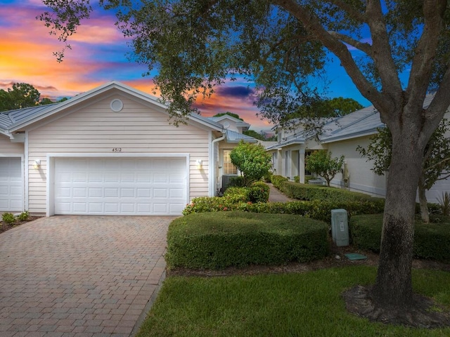 ranch-style home featuring a garage