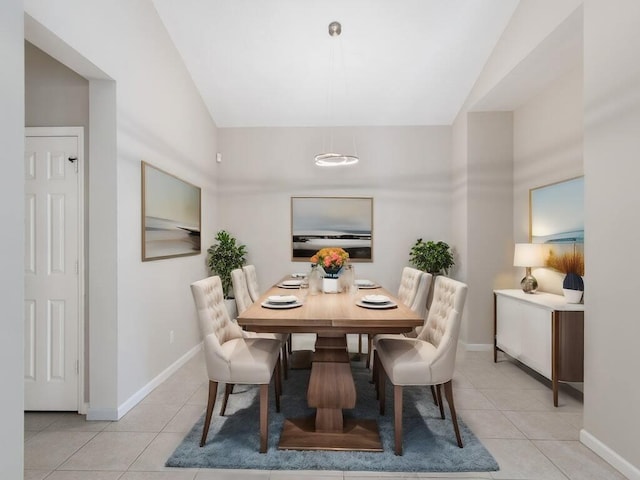 tiled dining space with lofted ceiling