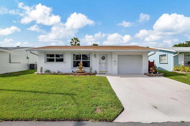 ranch-style home with a garage, a front yard, and central AC unit