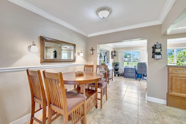 tiled dining space featuring a textured ceiling and ornamental molding