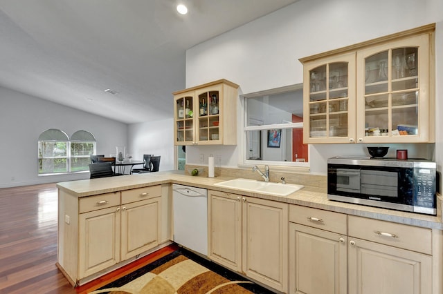 kitchen featuring hardwood / wood-style floors, kitchen peninsula, sink, and white dishwasher