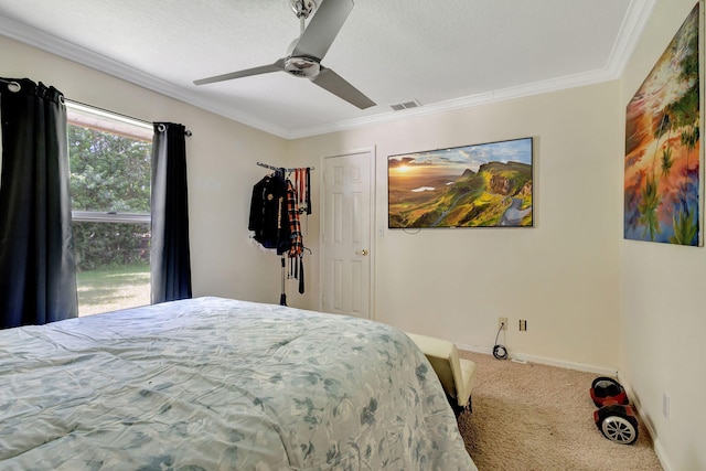 carpeted bedroom with ceiling fan and ornamental molding