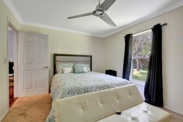 bedroom featuring a textured ceiling, crown molding, ceiling fan, and light carpet