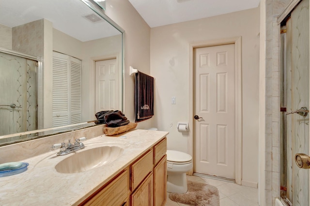 bathroom with tile patterned floors, walk in shower, toilet, and vanity