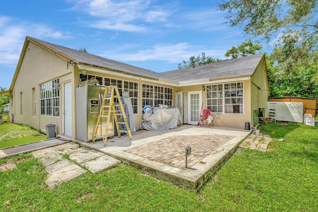 rear view of house with a patio area and a yard