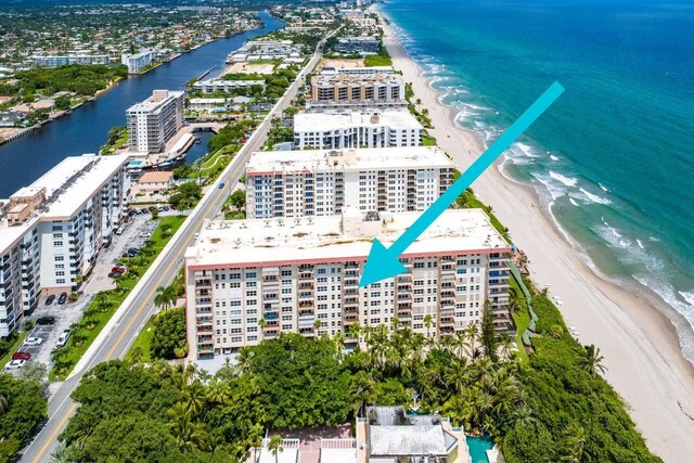 bird's eye view featuring a view of the beach and a water view