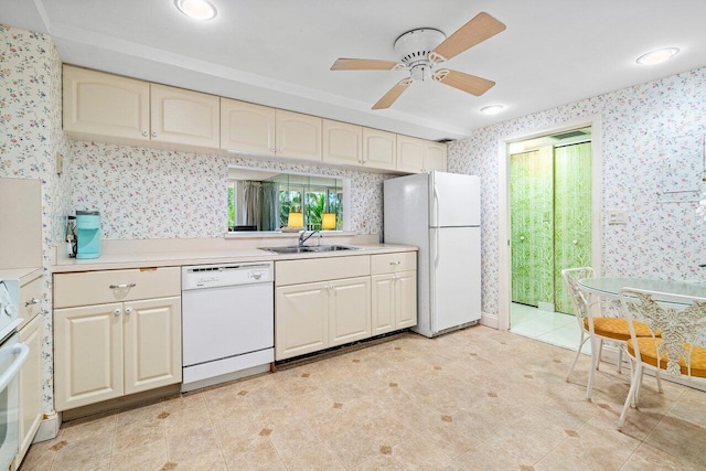 kitchen with white appliances, cream cabinets, sink, and ceiling fan