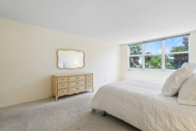 carpeted bedroom with a textured ceiling