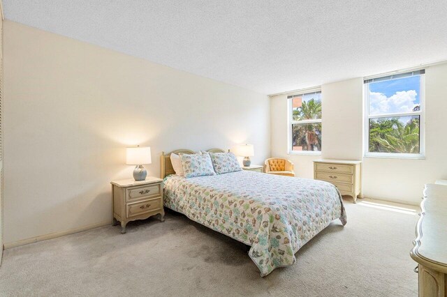 carpeted bedroom featuring a textured ceiling