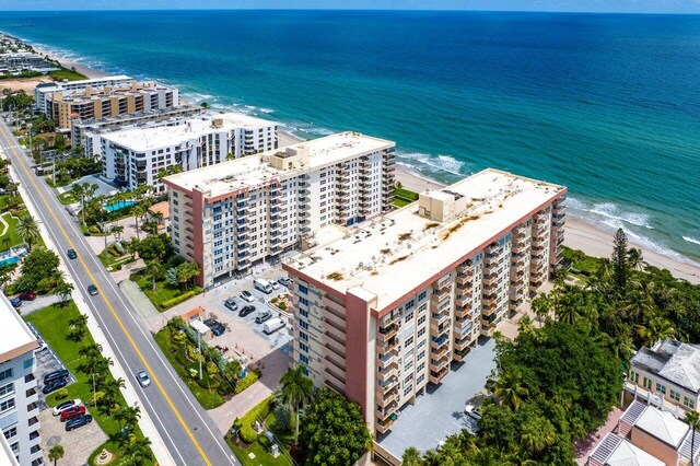 drone / aerial view featuring a view of the beach and a water view