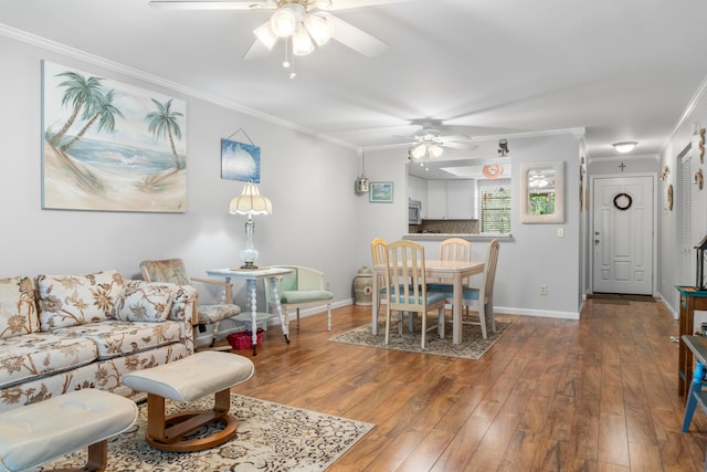 living room with ceiling fan, crown molding, and hardwood / wood-style floors