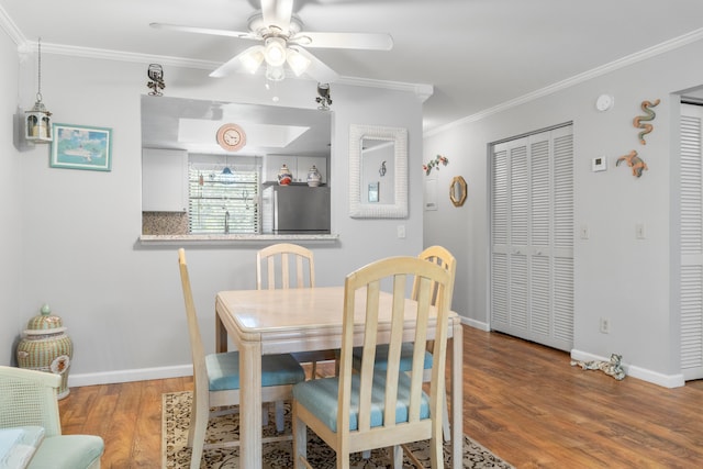 dining space featuring ceiling fan, hardwood / wood-style flooring, and ornamental molding