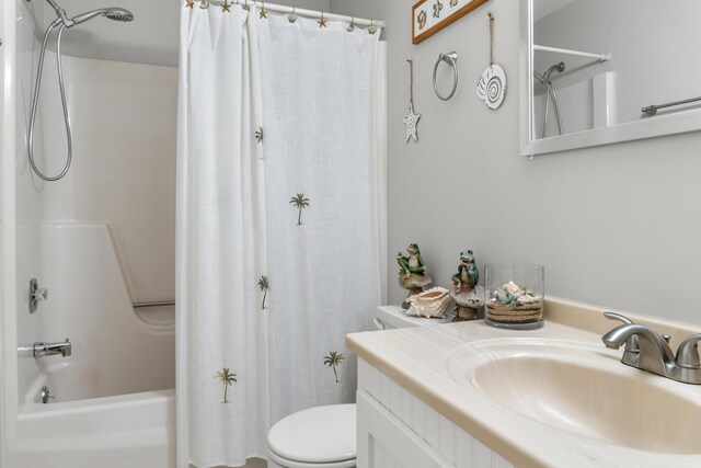 full bathroom with shower / tub combo with curtain, vanity, and toilet