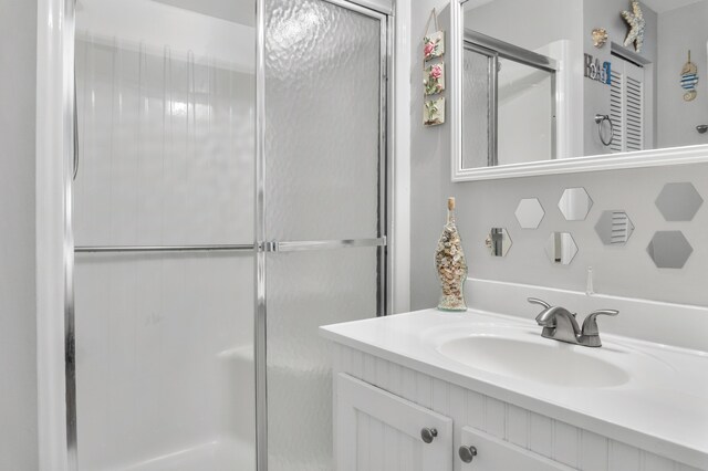 bathroom featuring vanity and an enclosed shower