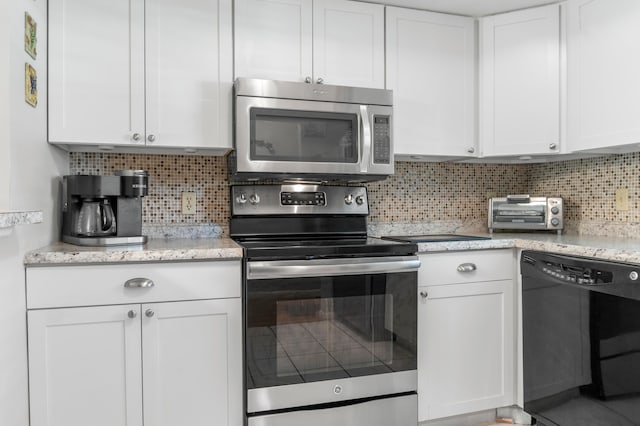 kitchen with backsplash, white cabinetry, and stainless steel appliances