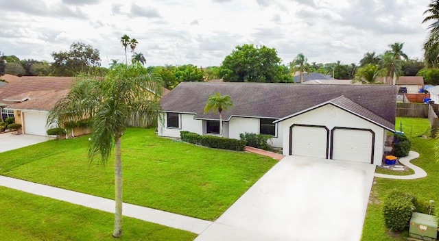 ranch-style house featuring a garage and a front lawn