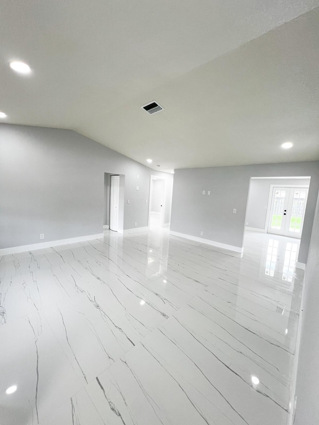 spare room featuring vaulted ceiling