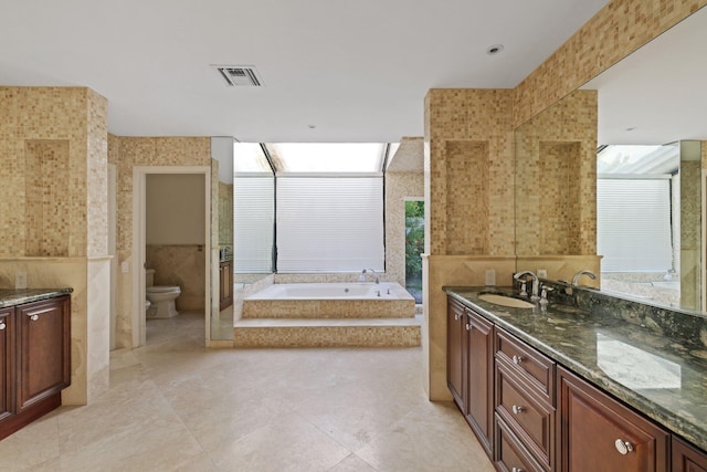 bathroom featuring a garden tub, visible vents, toilet, vanity, and tile patterned flooring