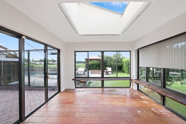 unfurnished sunroom with a skylight